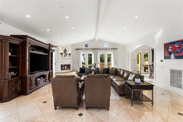 a living room with fireplace furniture and a flat screen tv