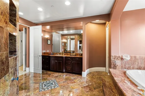 a large bathroom with a tub and shower