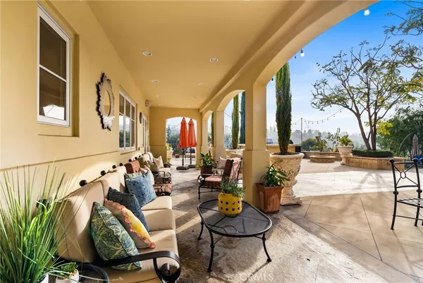 a building outdoor space with patio furniture and potted plants