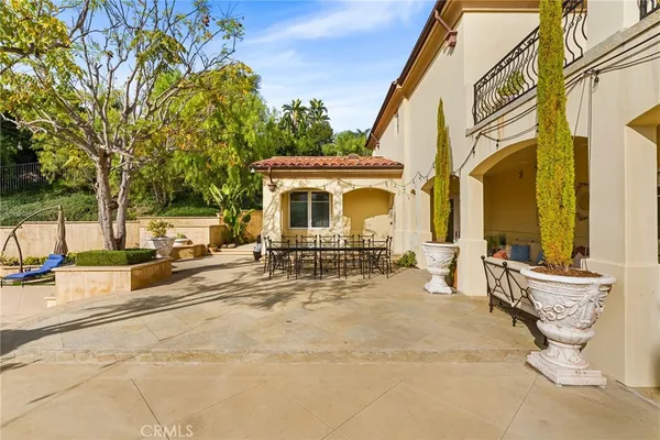 a view of a patio with a table and chairs and potted plants