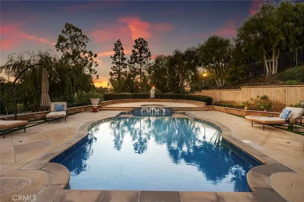 a view of swimming pool with outdoor seating and plants