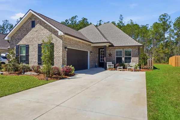 a view of a house with patio and garden