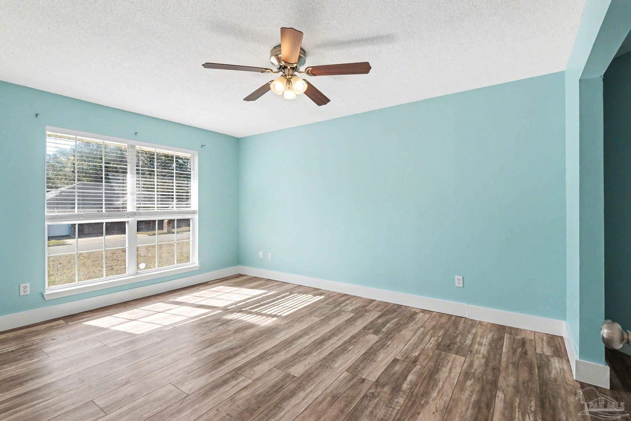 1648 Condor Drive Cantonment, FL 32533 - Photo 13 of 51 a view of empty room with wooden floor and fan