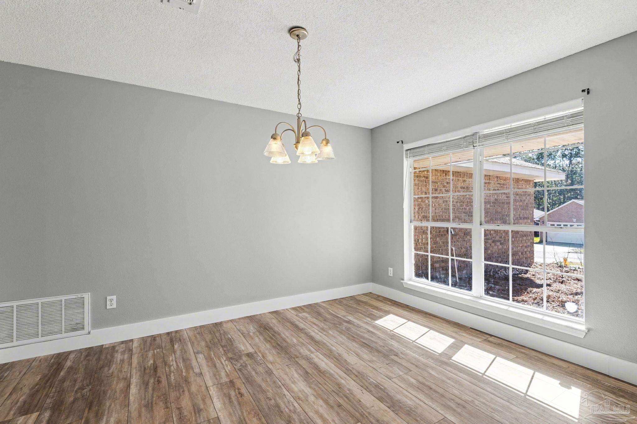 1648 Condor Drive Cantonment, FL 32533 - Photo 15 of 51 a view of empty room with wooden floor and fan