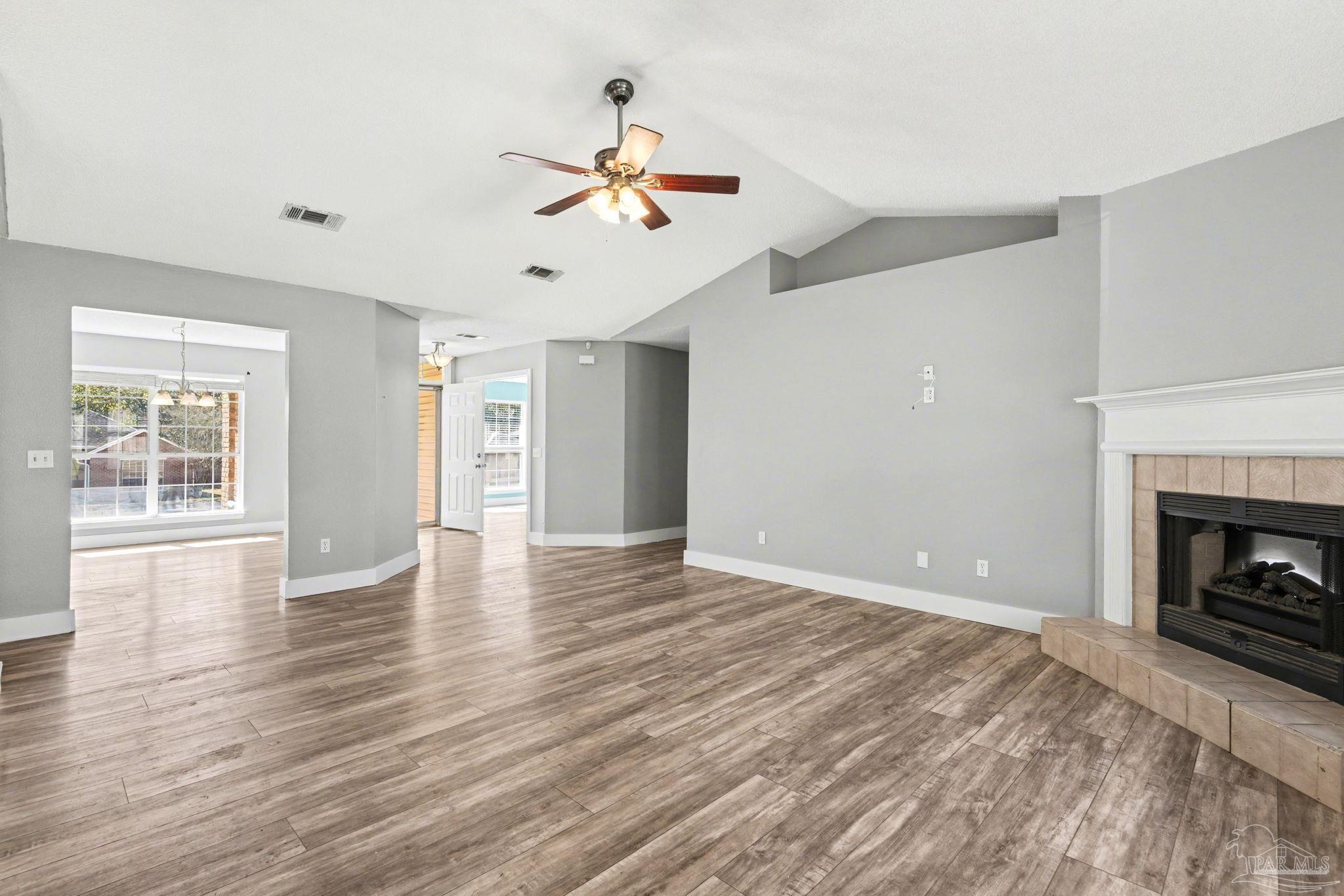 1648 Condor Drive Cantonment, FL 32533 - Photo 19 of 51 a view of empty room with wooden floor and fireplace