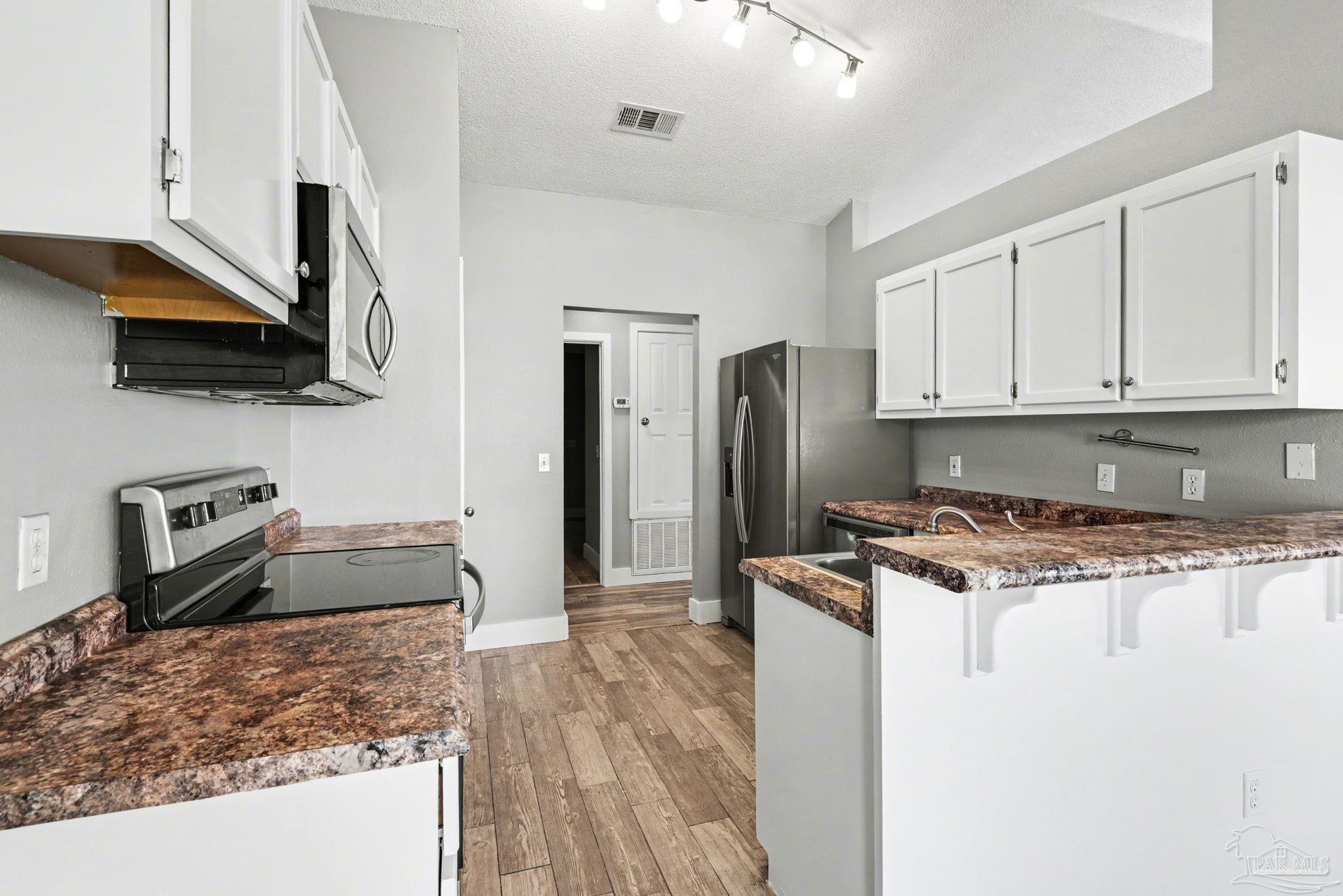 1648 Condor Drive Cantonment, FL 32533 - Photo 22 of 51 a kitchen with stainless steel appliances granite countertop a stove refrigerator and a sink