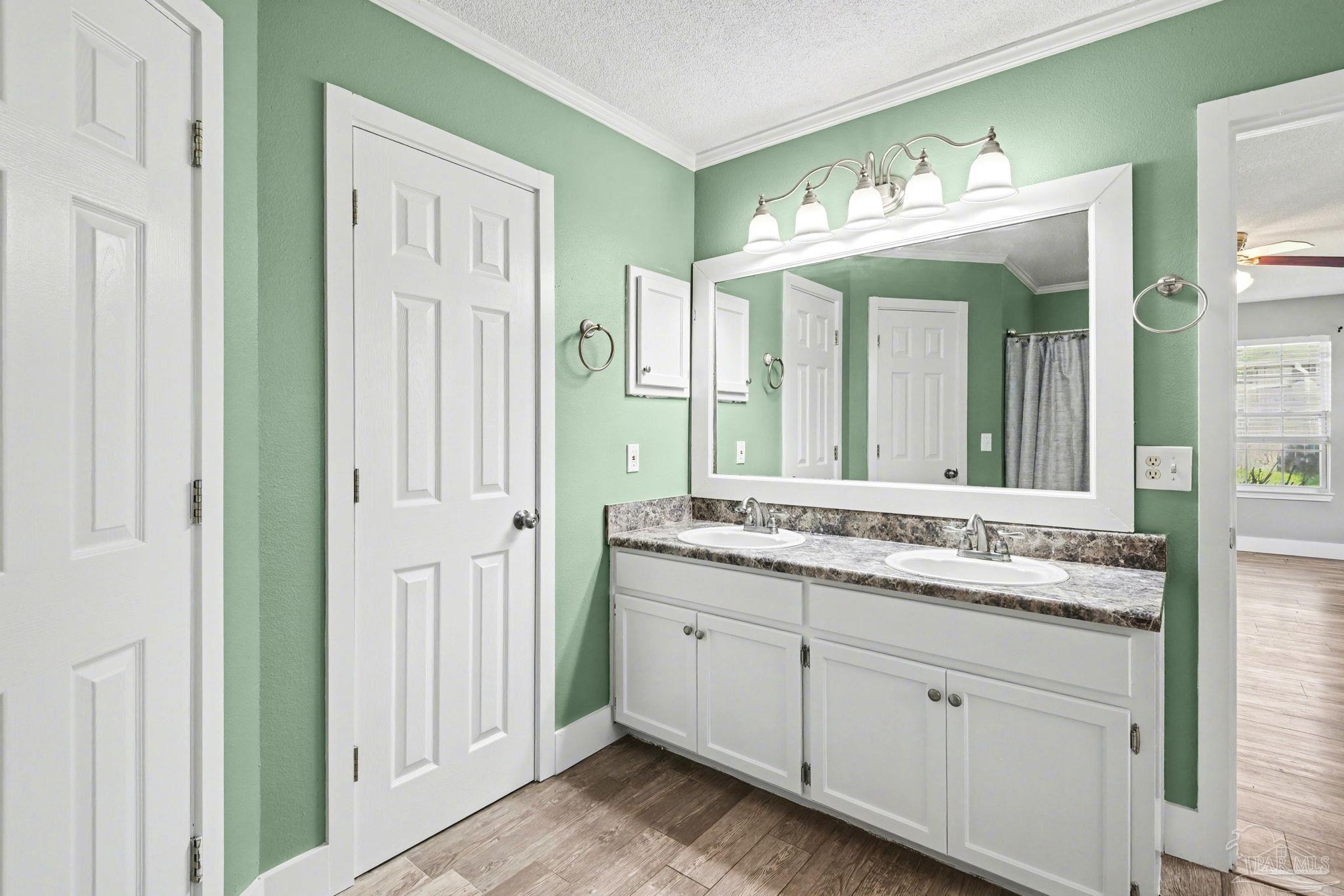 1648 Condor Drive Cantonment, FL 32533 - Photo 31 of 51 a bathroom with a granite countertop sink vanity and mirror