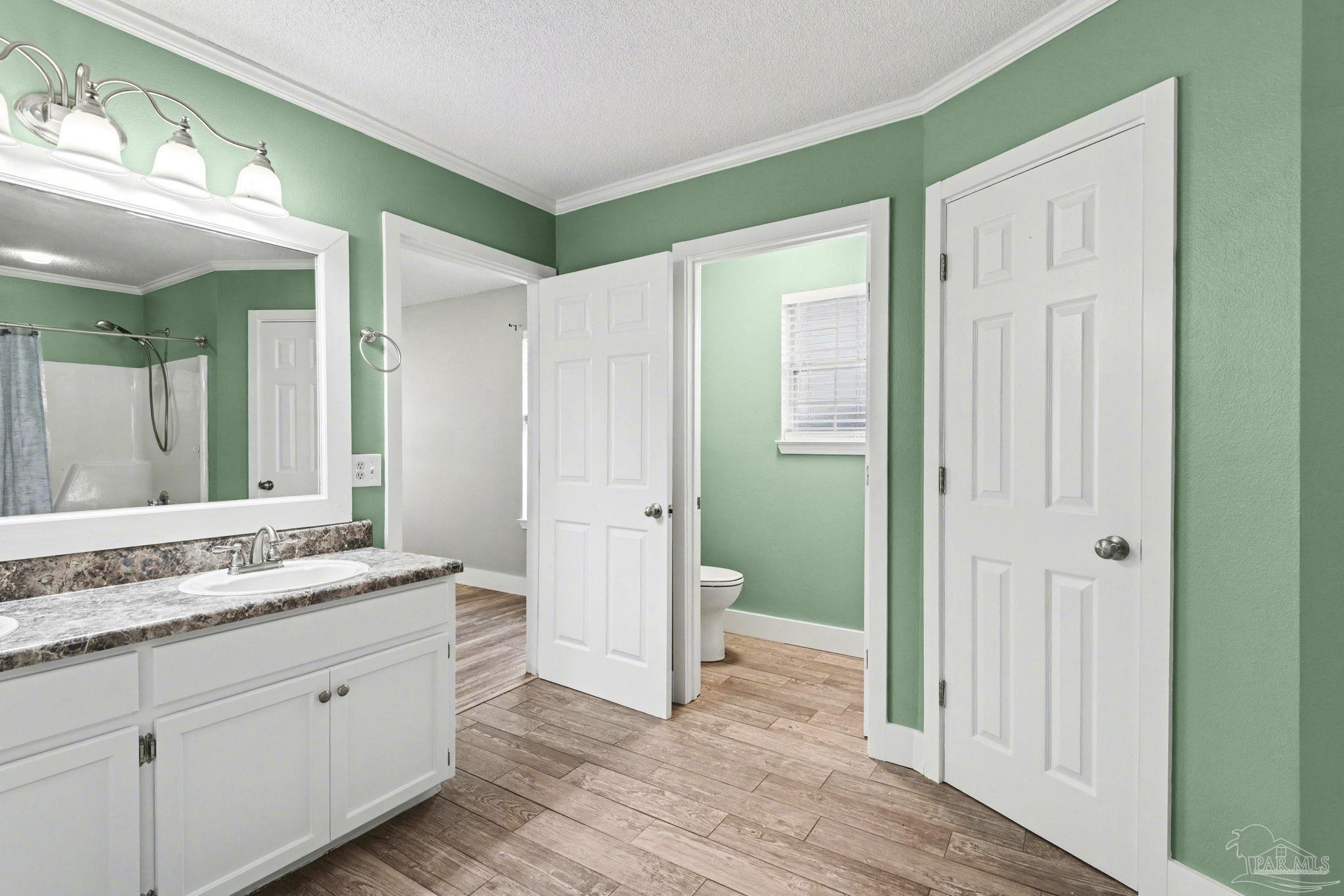 1648 Condor Drive Cantonment, FL 32533 - Photo 33 of 51 a spacious bathroom with a granite countertop sink and a mirror