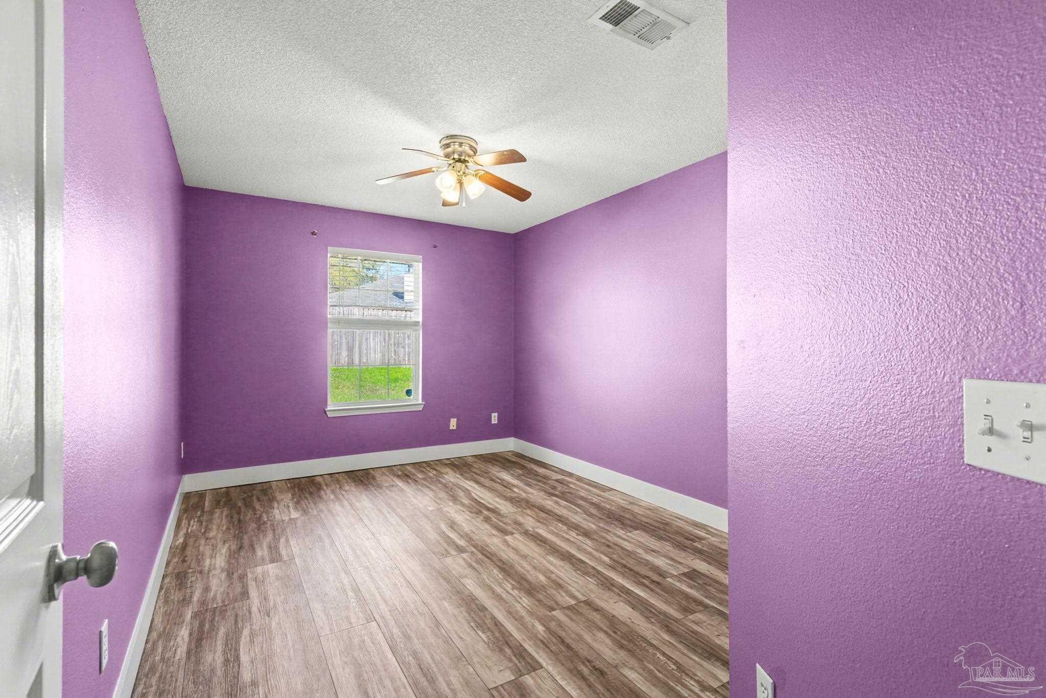 1648 Condor Drive Cantonment, FL 32533 - Photo 36 of 51 a view of empty room with window and wooden floor