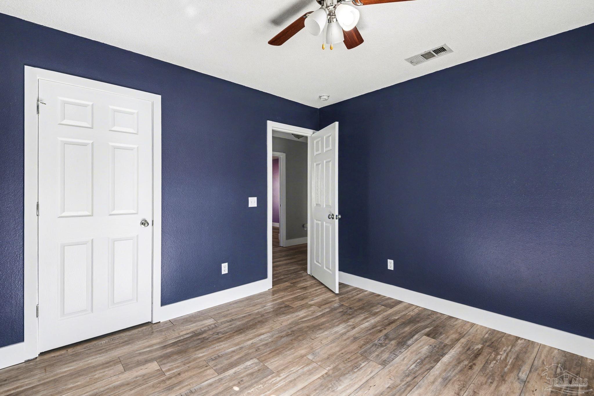 1648 Condor Drive Cantonment, FL 32533 - Photo 42 of 51 an empty room with wooden floor and entryway