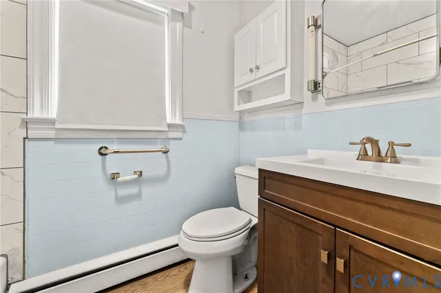 a bathroom with a sink a toilet and vanity