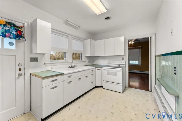 a kitchen with granite countertop a stove top oven sink and cabinets