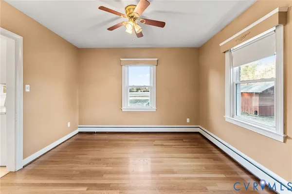 wooden floor in an empty room with a window