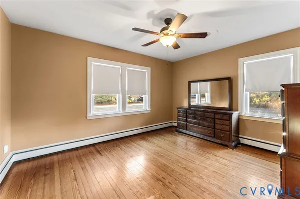 wooden floor in an empty room with a window