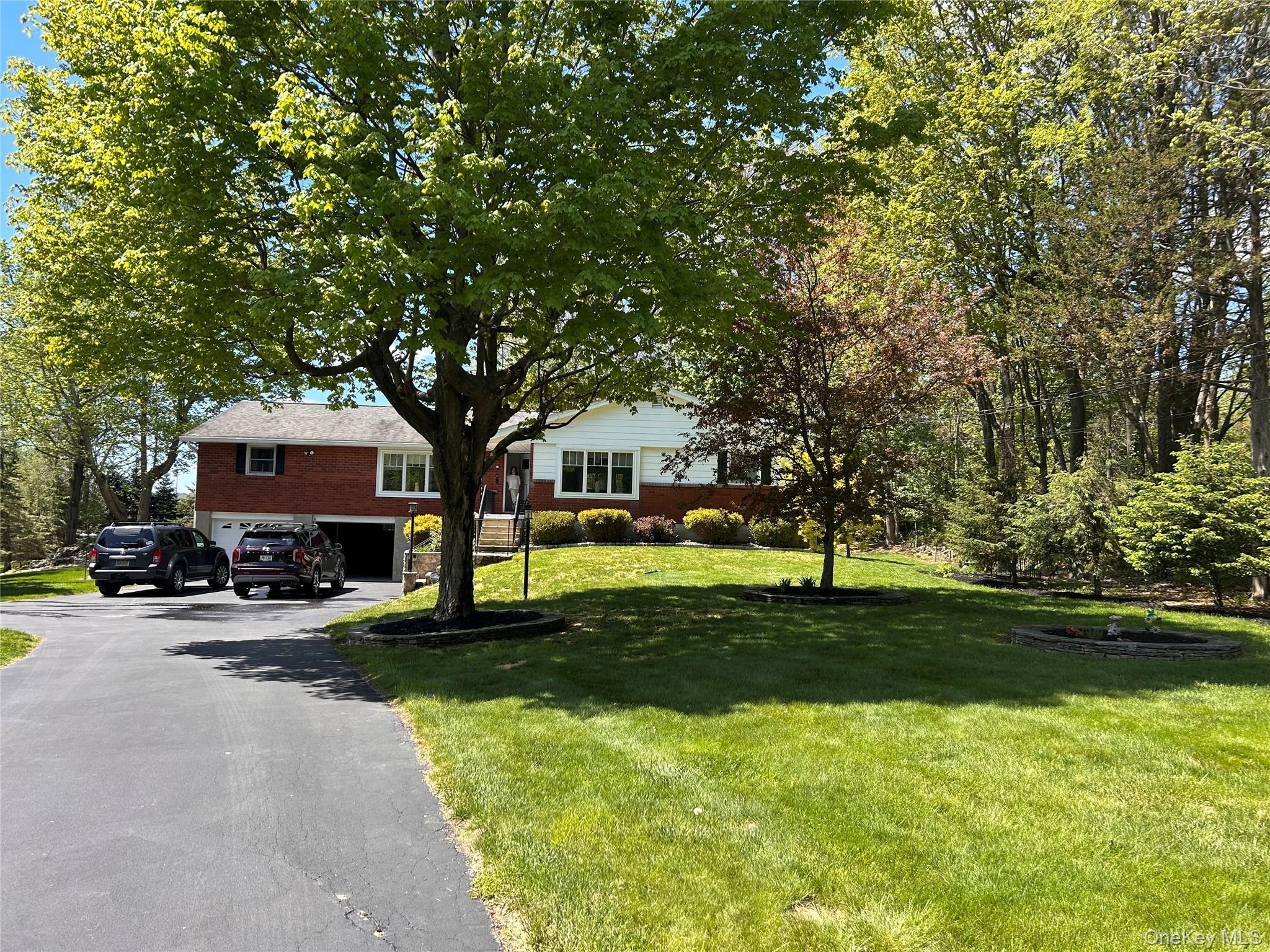 58 Wheaton Avenue Fishkill, NY 12524 - Photo 1 of 20 a front view of a house with garden and trees