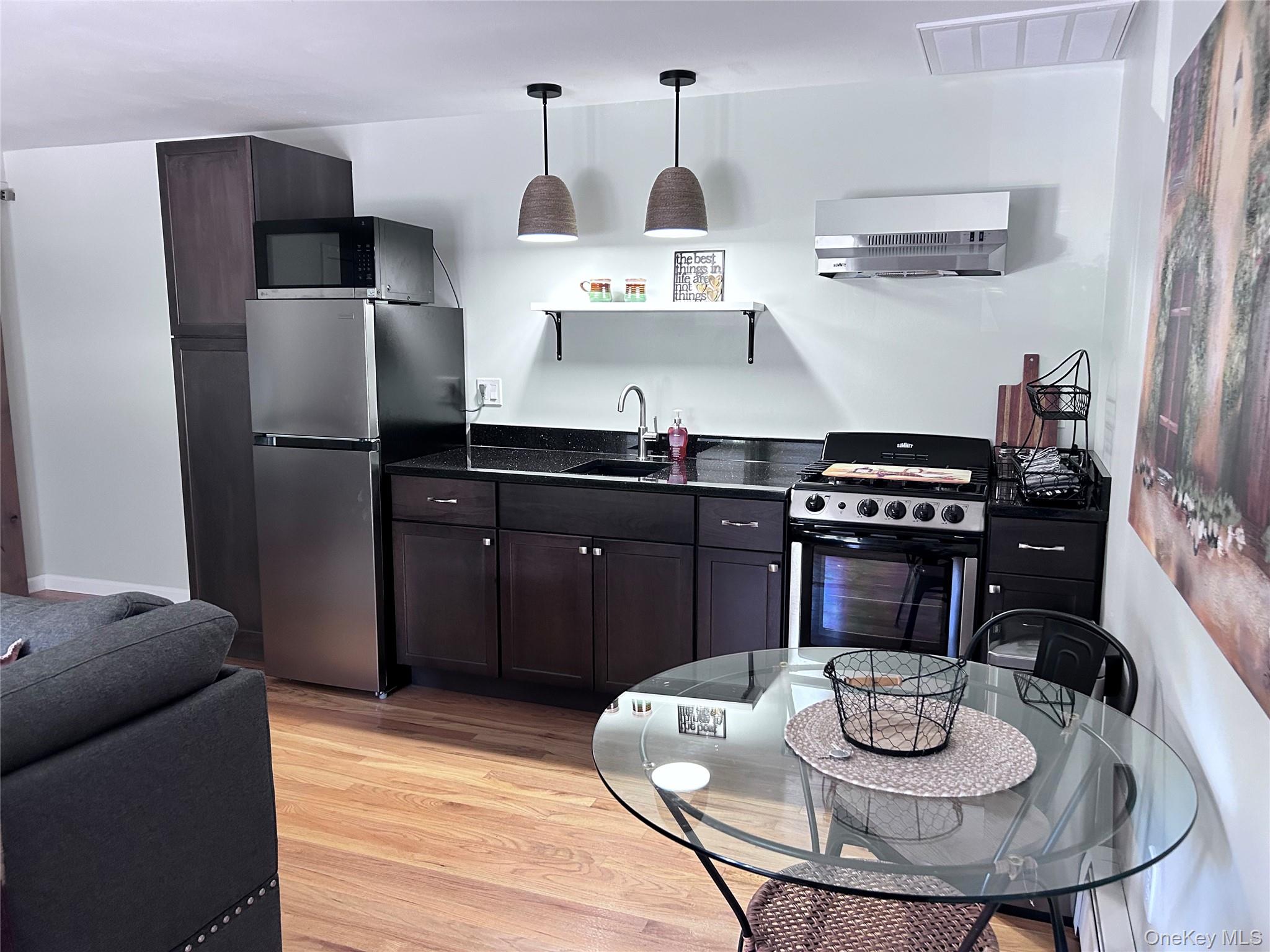 58 Wheaton Avenue Fishkill, NY 12524 - Photo 20 of 20 a kitchen with stainless steel appliances a dining table and chairs