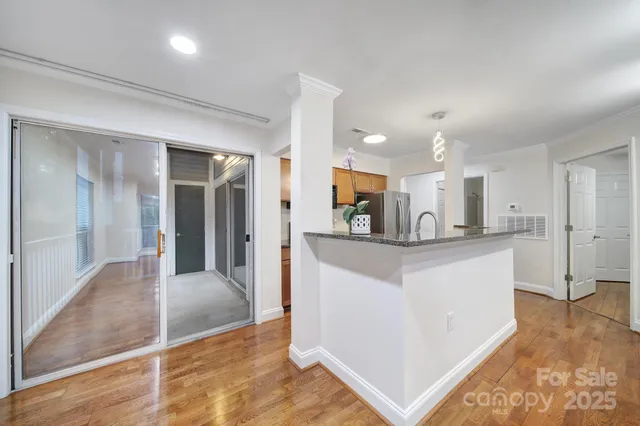 a open kitchen with stainless steel appliances kitchen island a refrigerator sink and cabinets