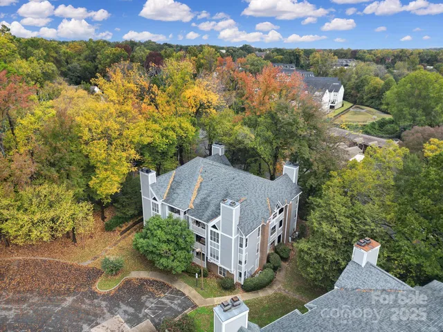an aerial view of a houses with a yard