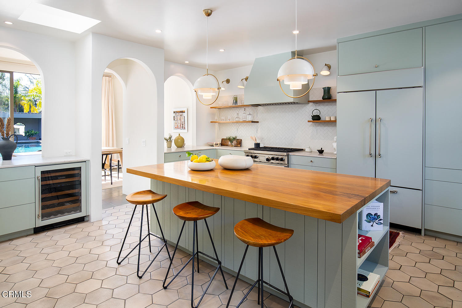 490 La Loma Road Pasadena, CA 91105 - Photo 20 of 59 a kitchen with stainless steel appliances kitchen island a table chairs in it and wooden floors