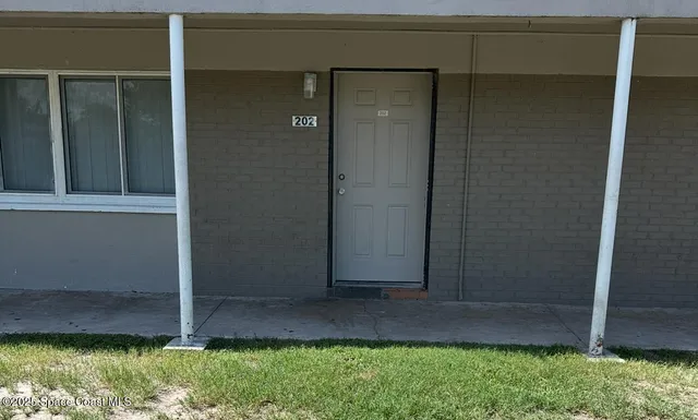 a view of a kitchen with kitchen island wooden floor stainless steel appliances and cabinets