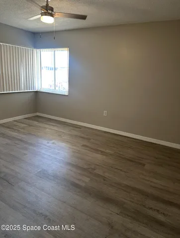 a bathroom with a granite countertop sink toilet and mirror