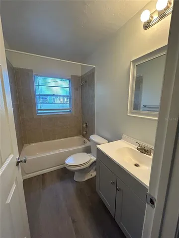 a bathroom with a double vanity sink toilet and bathtub