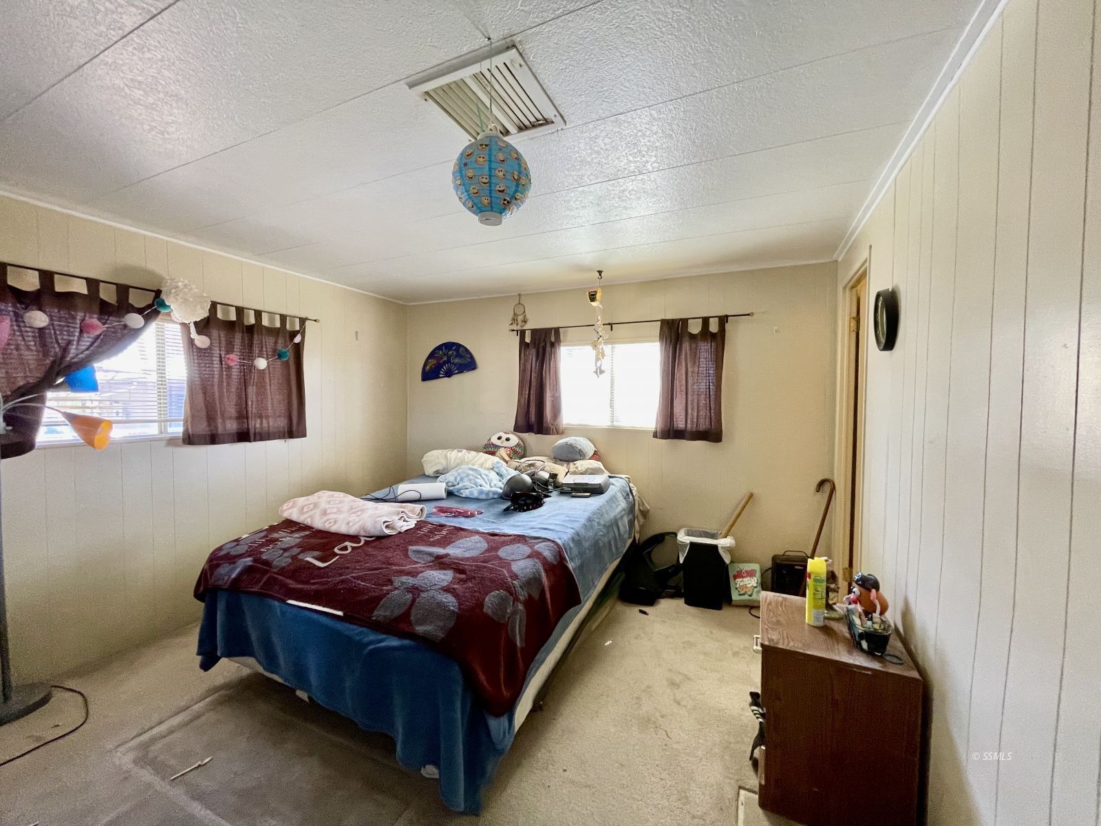5237 Nolina Avenue Ridgecrest, CA 93555 - Photo 16 of 27 a bedroom with a bed ceiling fan and a window