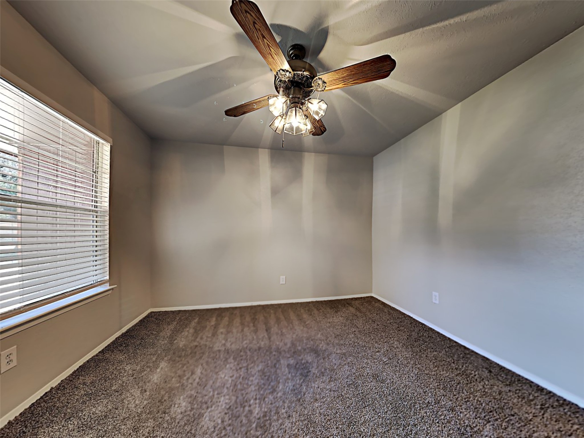 14919 Wainsfield Lane Channelview, TX 77530 - Photo 12 of 17 an empty room with a ceiling fan and window