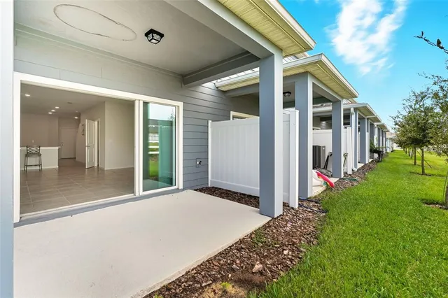 a view of a house with backyard and porch