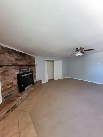 a view of empty room with a fireplace