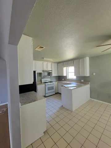 a kitchen with stainless steel appliances granite countertop a sink and cabinets