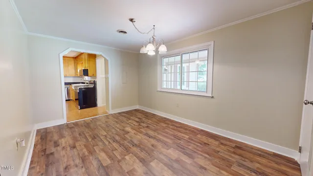 a view of a kitchen with a sink and refrigerator in a kitchen