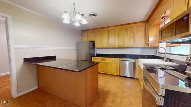 a kitchen with a stove a sink and a refrigerator