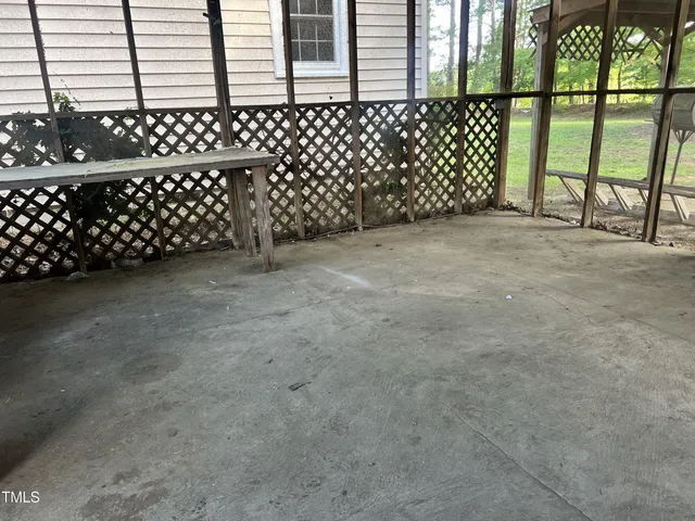 a view of a house with a yard and large tree