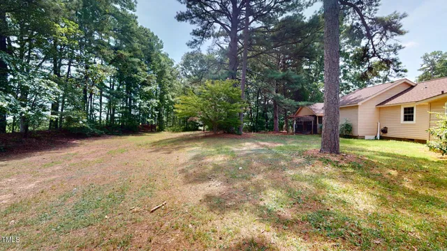a front view of a house with a yard and trees
