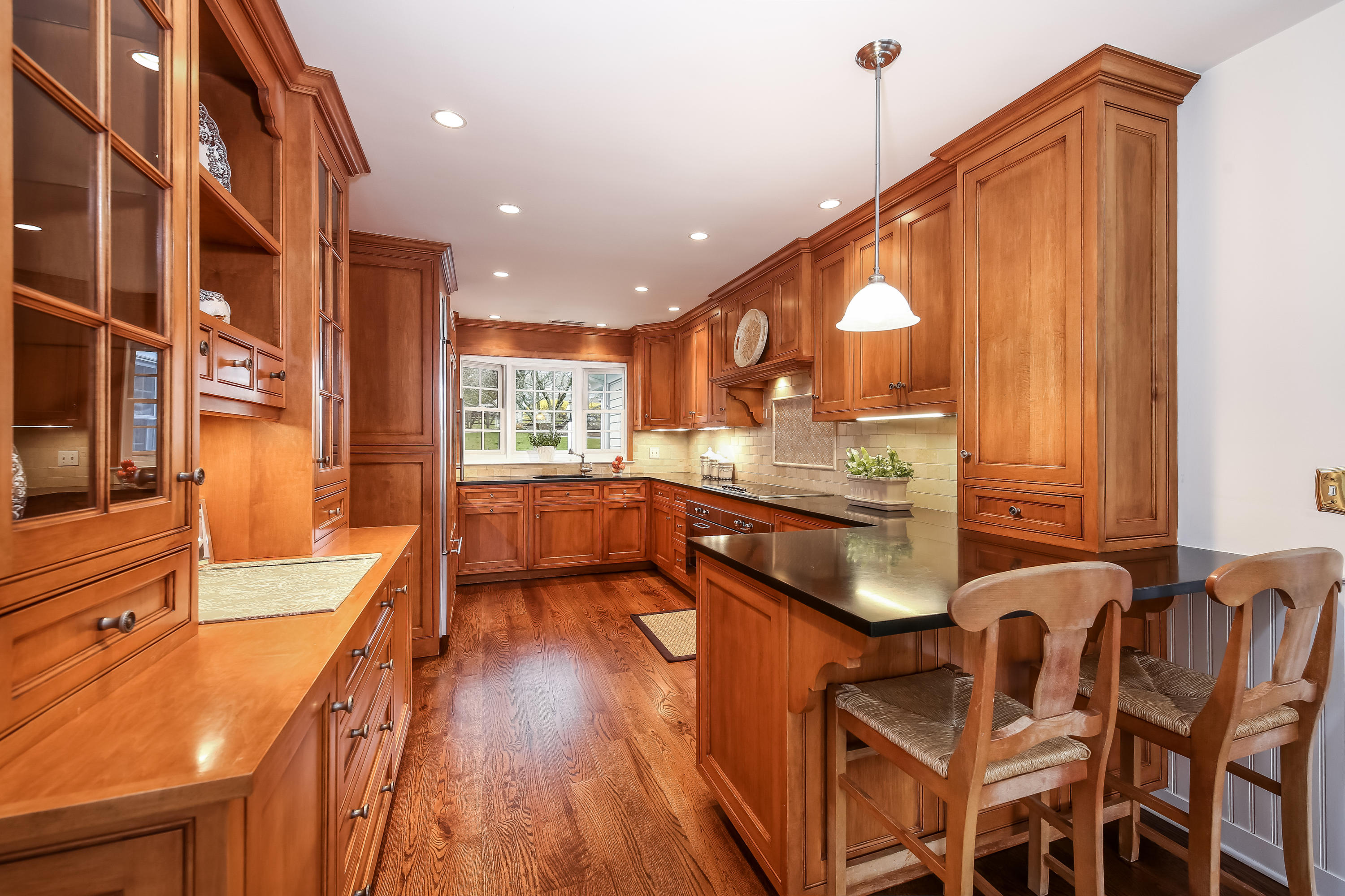 2 4 Acres Road Darien, CT 06820 - Photo 11 of 26 a kitchen with a table chairs in it and wooden floors