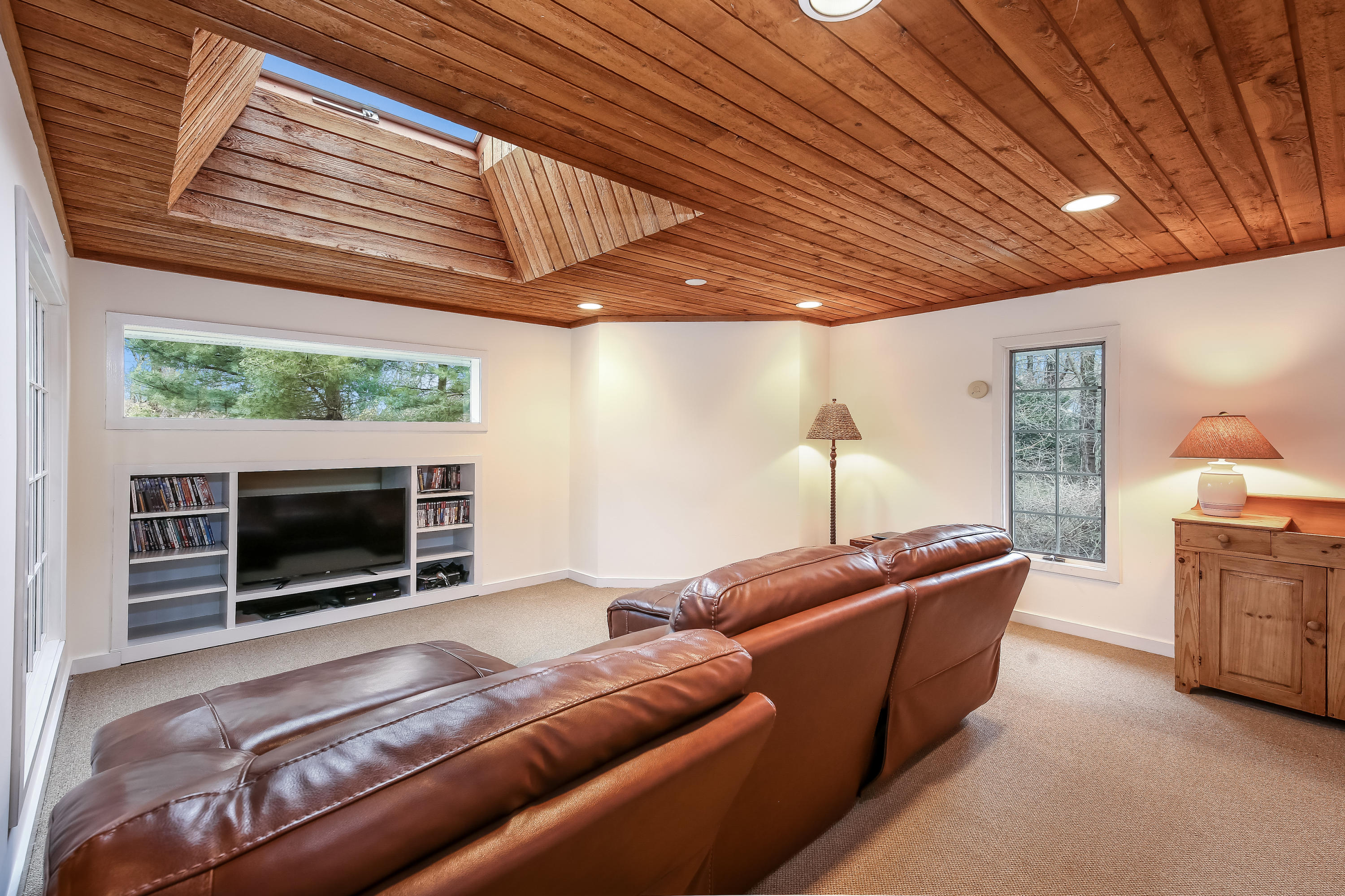 2 4 Acres Road Darien, CT 06820 - Photo 15 of 26 a living room with furniture a flat screen tv and a fireplace