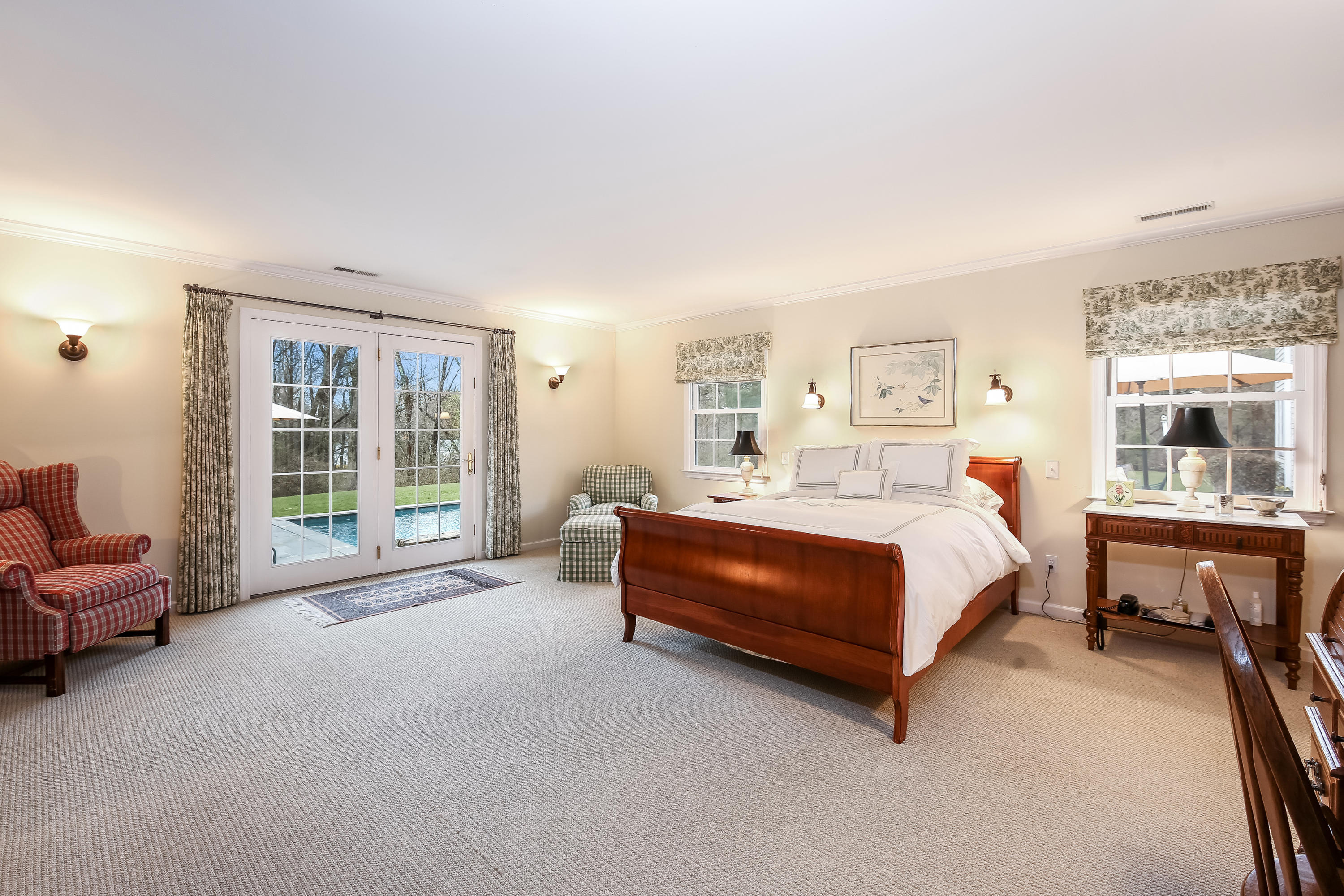2 4 Acres Road Darien, CT 06820 - Photo 18 of 26 a spacious bedroom with a bed and a window