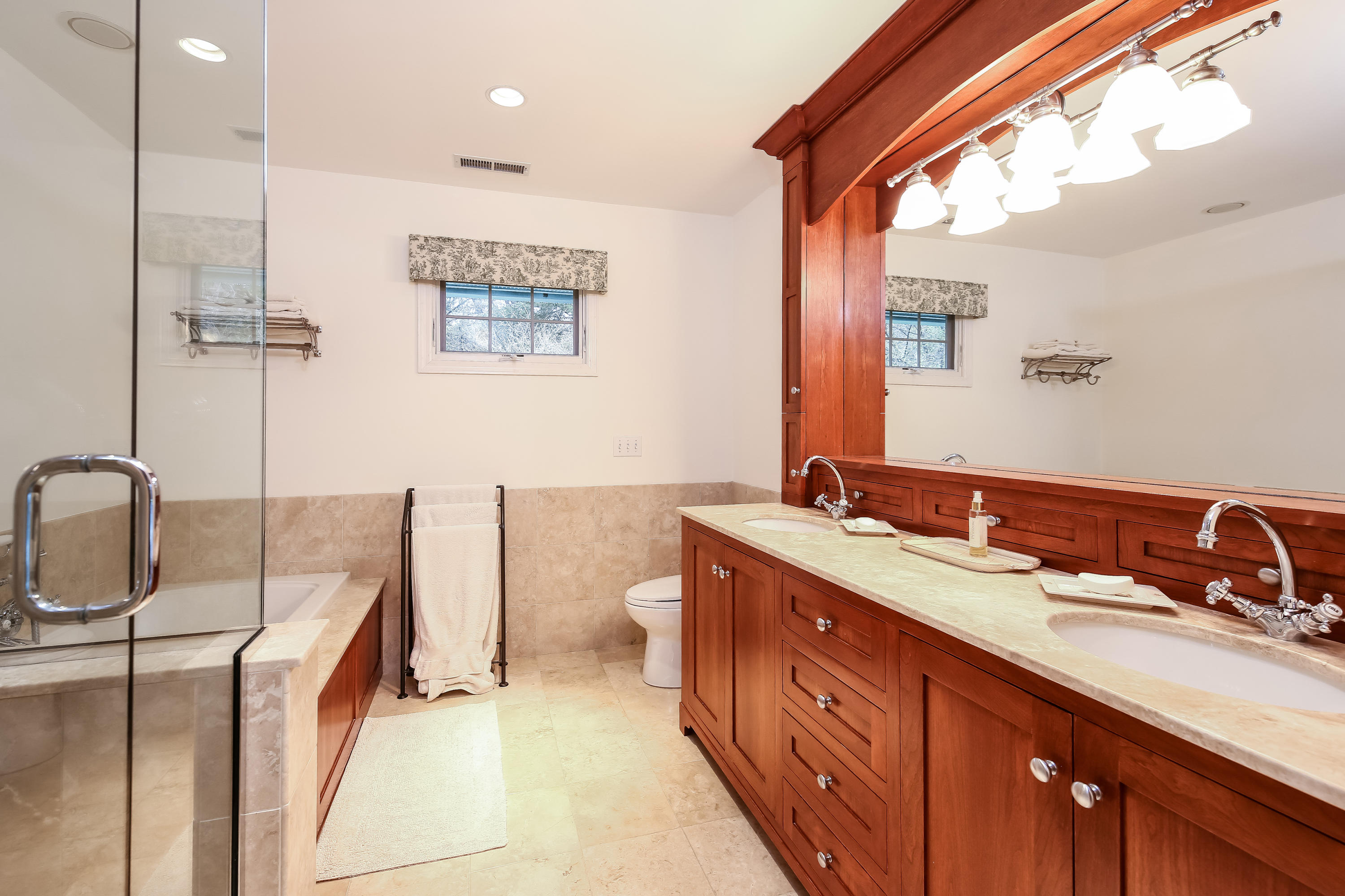 2 4 Acres Road Darien, CT 06820 - Photo 19 of 26 a spacious bathroom with a double vanity sink a mirror and a bathtub