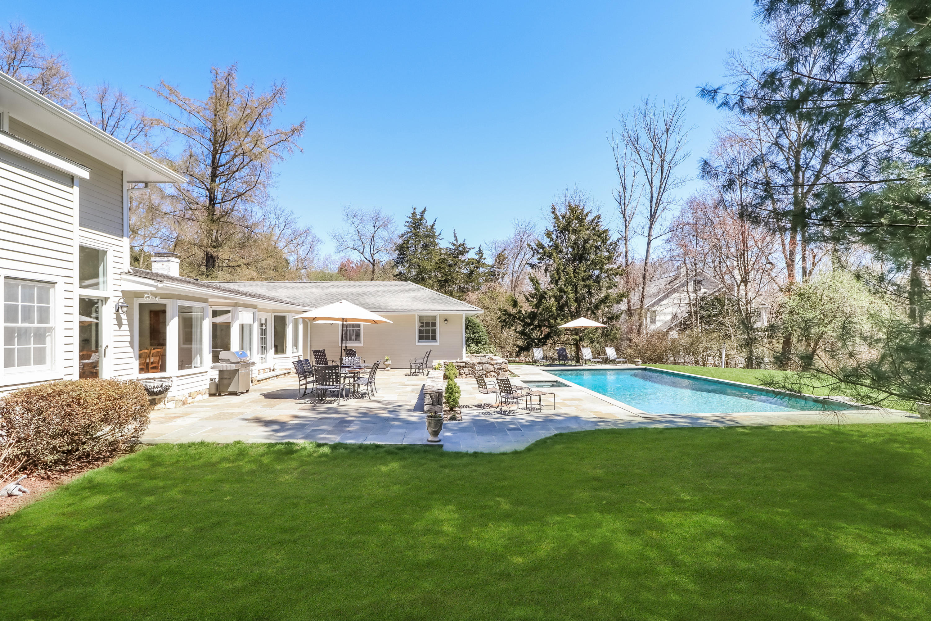 2 4 Acres Road Darien, CT 06820 - Photo 3 of 26 a front view of a house with garden and trees