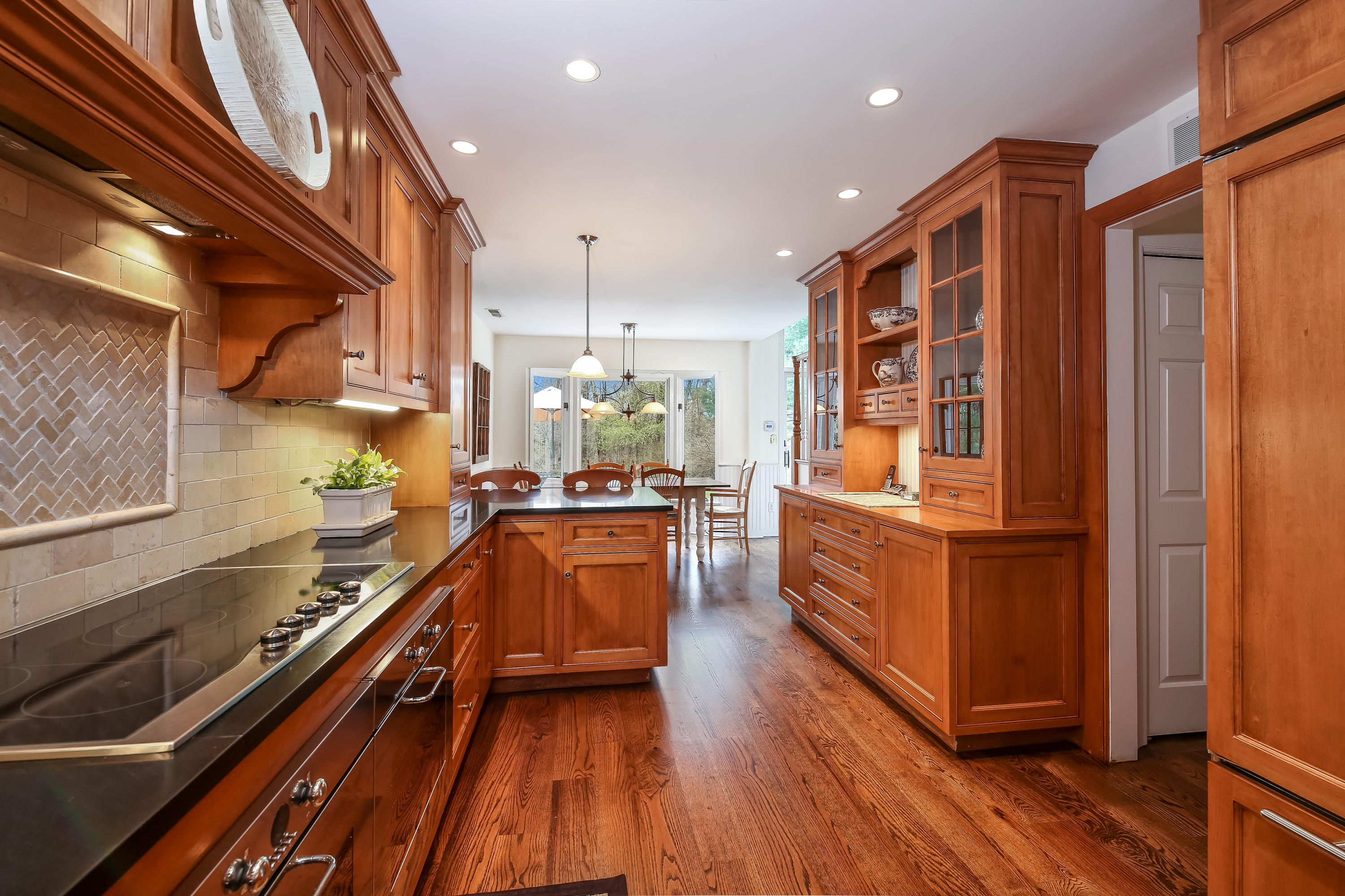 2 4 Acres Road Darien, CT 06820 - Photo 9 of 26 a kitchen with wooden floors and a sink