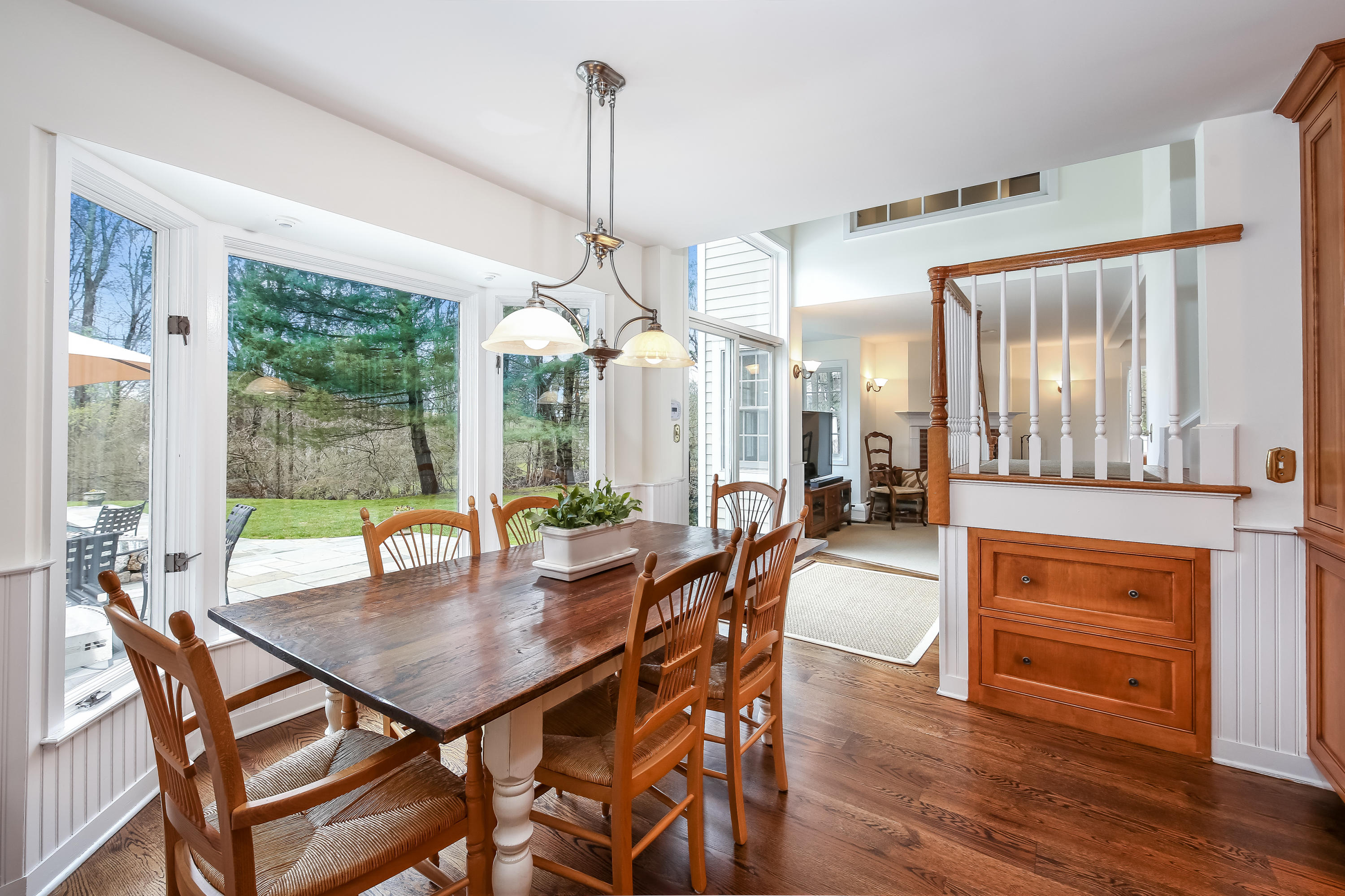 2 4 Acres Road Darien, CT 06820 - Photo 10 of 26 a view of a dining room and livingroom with furniture wooden floor a chandelier
