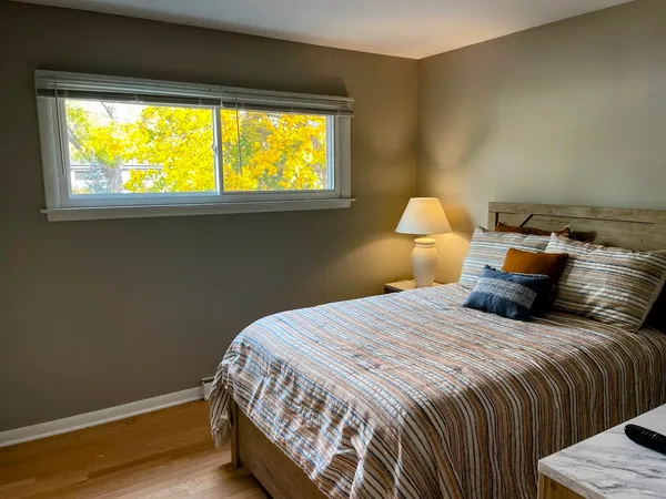 a bedroom with a bed and a window