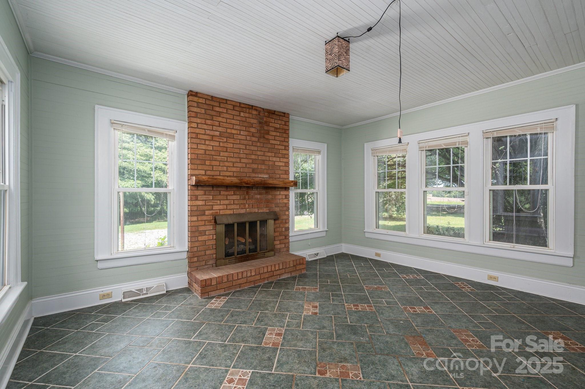 1173 Cat Square Road Vale, NC 28168 - Photo 14 of 33 an empty room with windows and fireplace