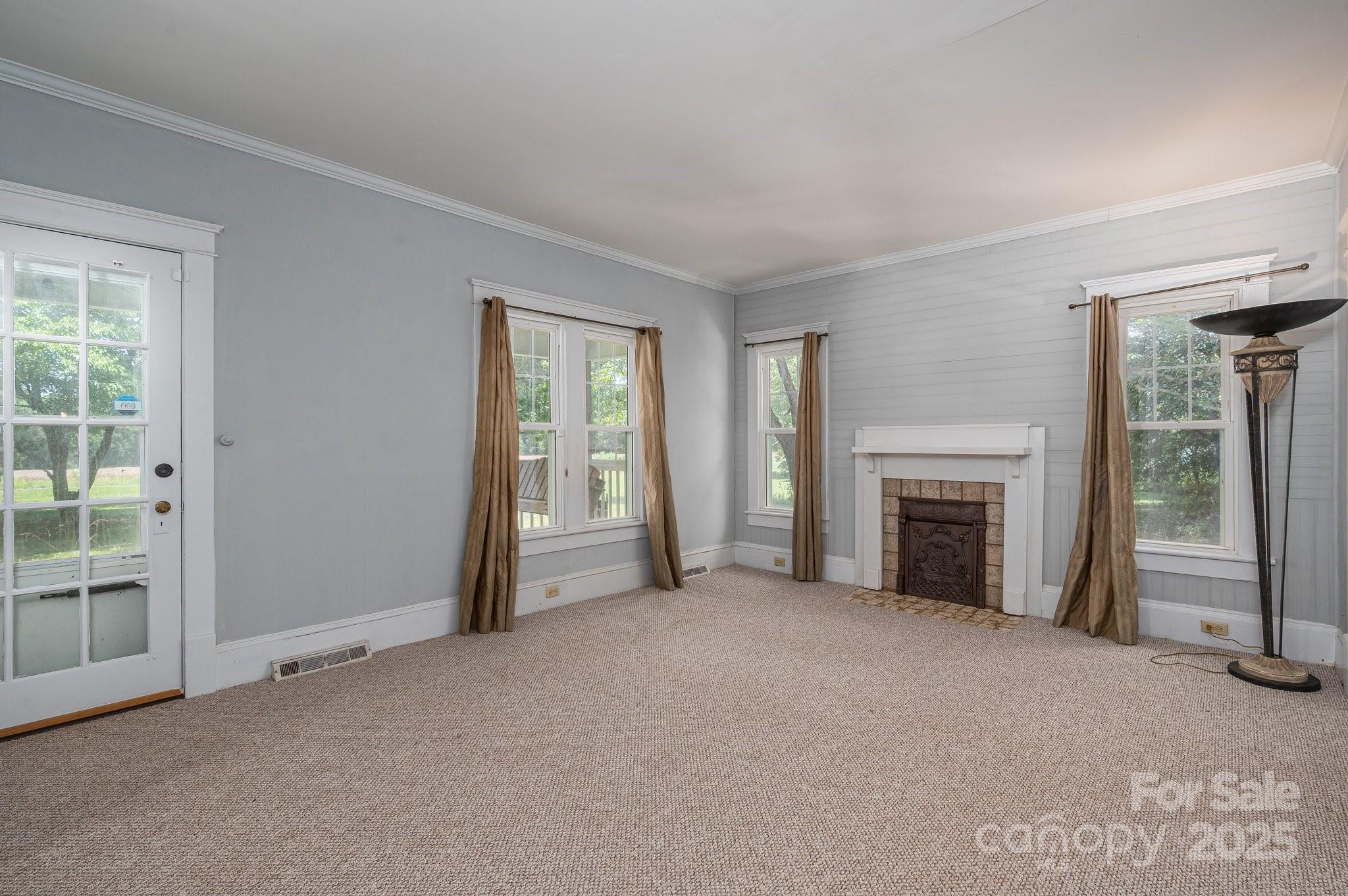 1173 Cat Square Road Vale, NC 28168 - Photo 4 of 33 an empty room with windows and fireplace