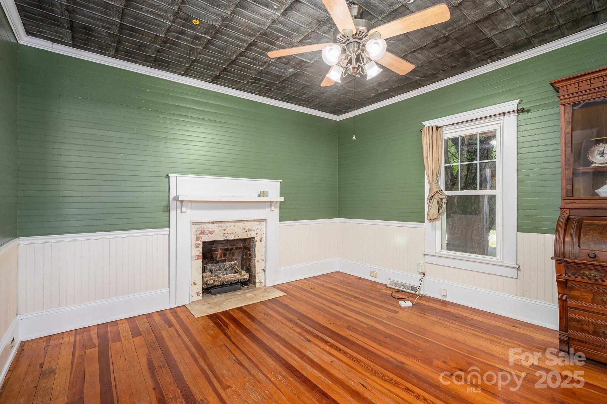 1173 Cat Square Road Vale, NC 28168 - Photo 7 of 33 a view of an empty room with wooden floor fireplace and a window