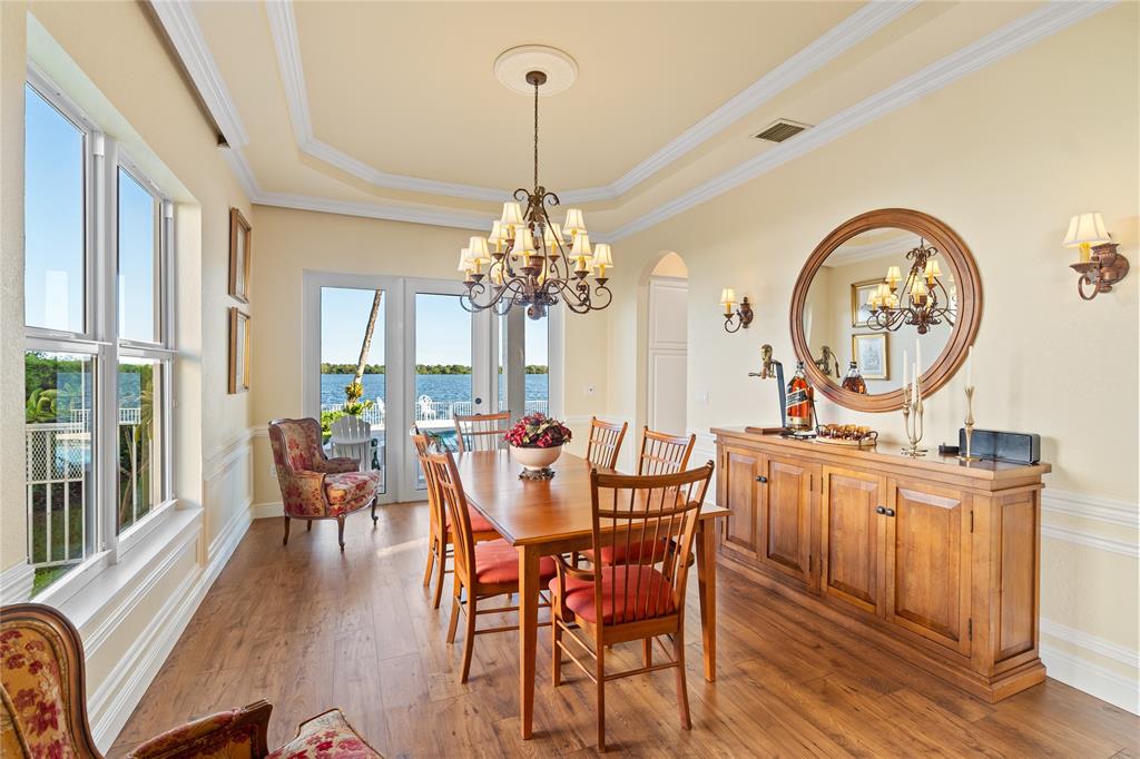 19239 Southwest 54th Street Miramar, FL 33029 - Photo 29 of 82 a view of a dining room with furniture a chandelier and wooden floor