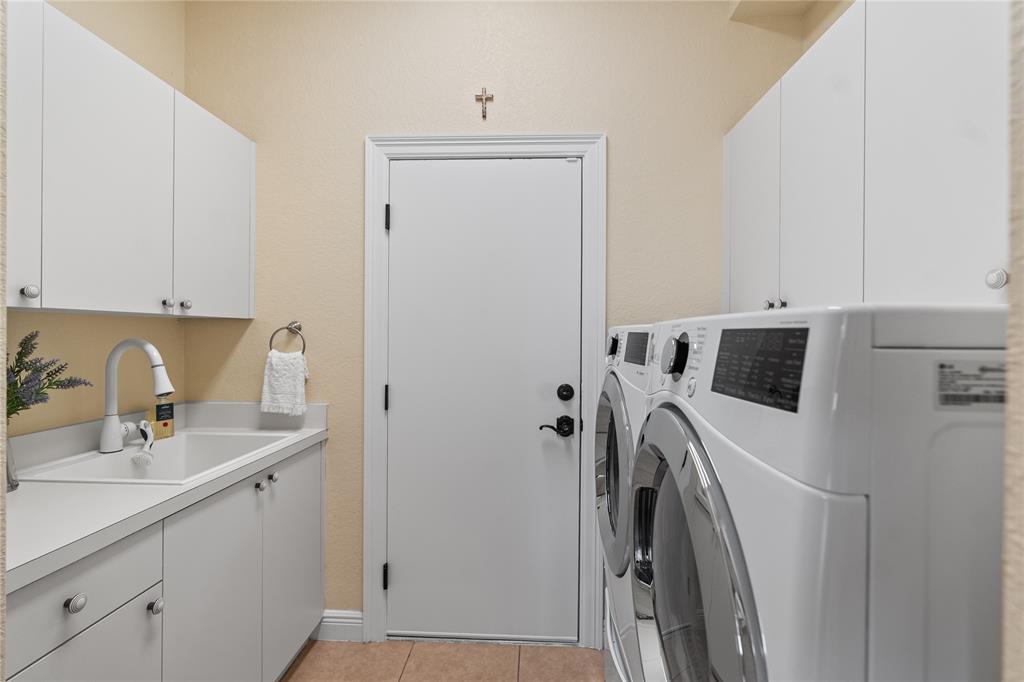 19239 Southwest 54th Street Miramar, FL 33029 - Photo 37 of 82 a utility room with cabinets washer and dryer