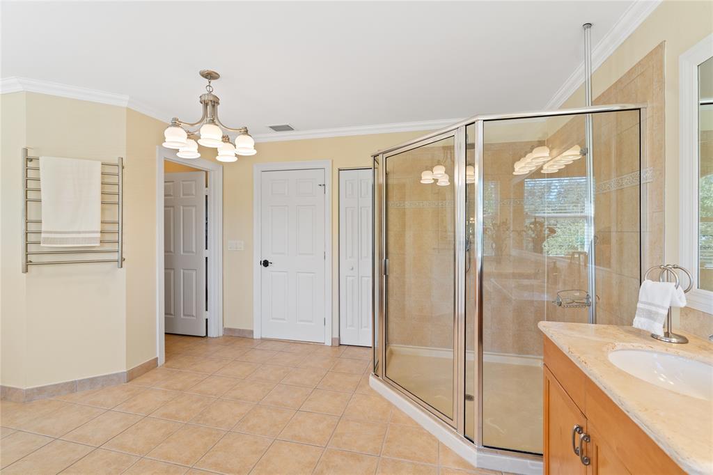 19239 Southwest 54th Street Miramar, FL 33029 - Photo 54 of 82 a spacious bathroom with a shower a sink and a mirror