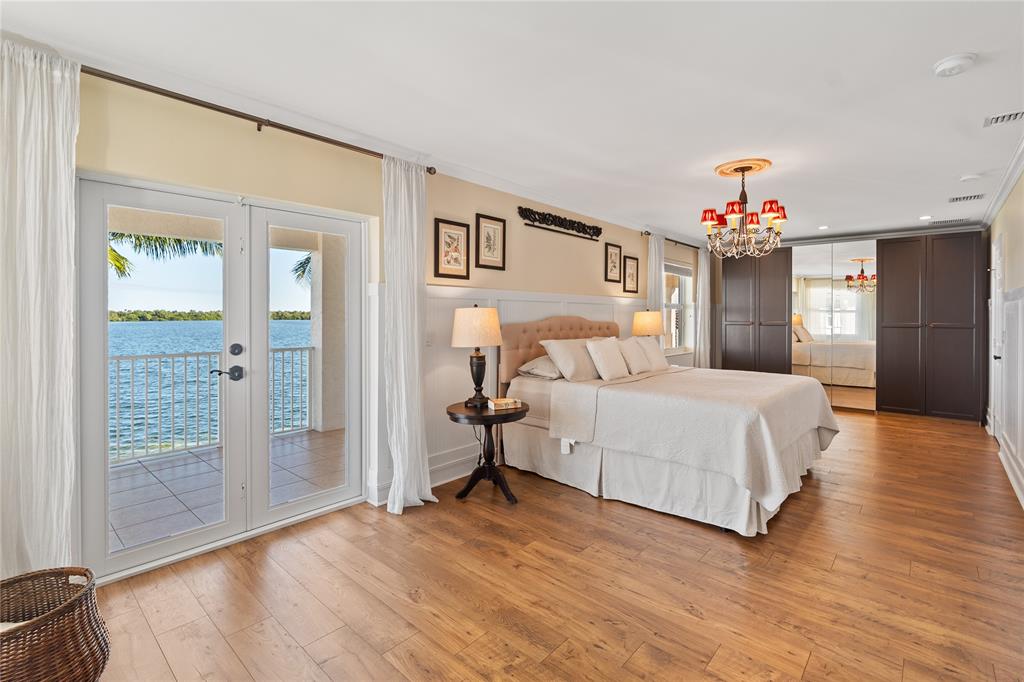 19239 Southwest 54th Street Miramar, FL 33029 - Photo 56 of 82 a spacious bedroom with a bed and a chandelier